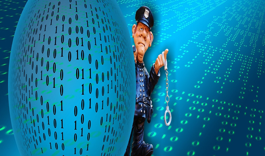 image of policemand with handcuffs against computer code background