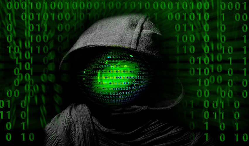 hooded hacker against backdrop of code
