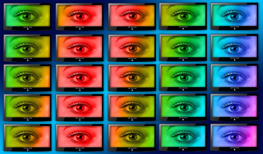 Multiple monitor screens, each displaying an eyeball