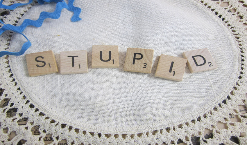 the word 'stupid' spelled out in scrabble tiles