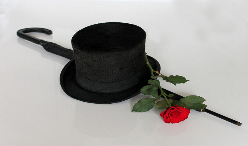 Photo of a black top hat and a red rose