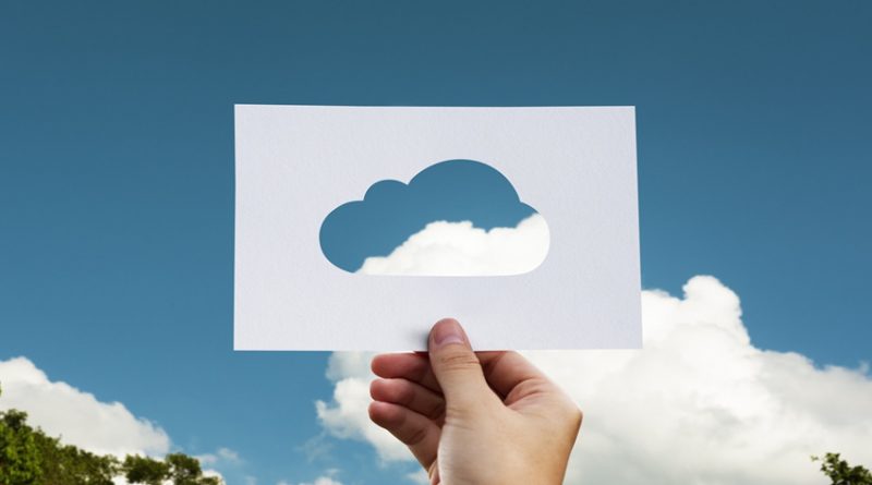 A cut out cloud template held up against real sky