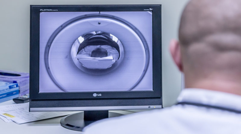doctor looking at MRI scanner
